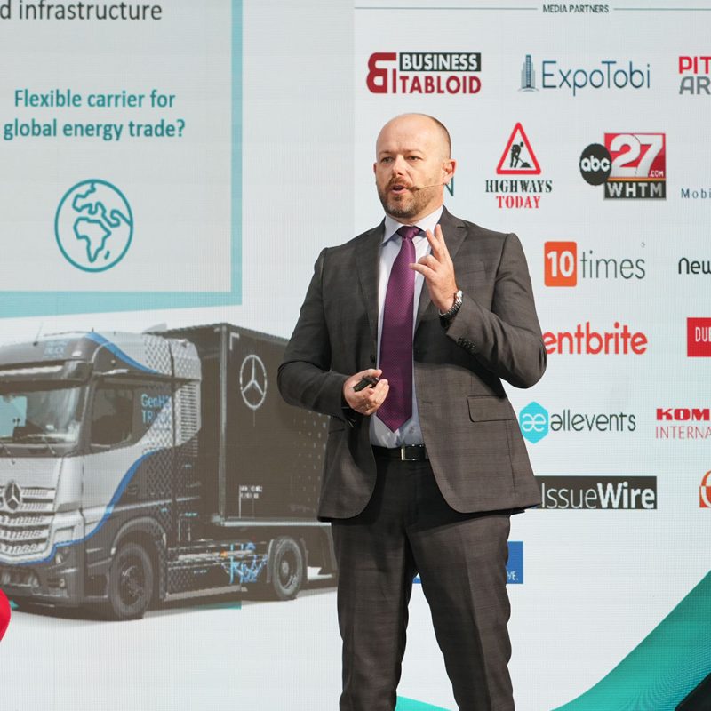 A vibrant conference organized by a leading event company in Dubai, showcasing a large, well-lit venue with attendees engaged in discussions and presentations.